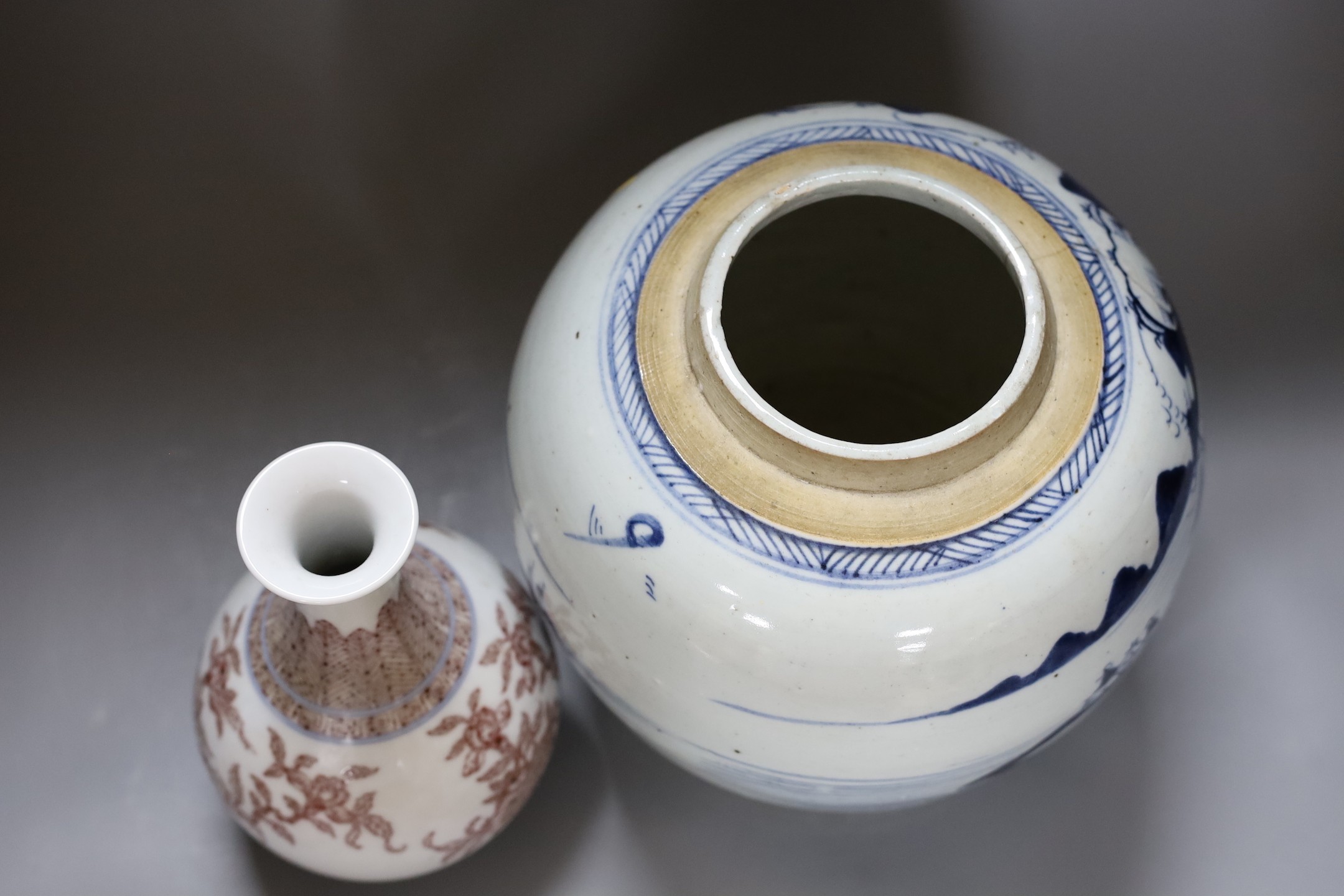 A Chinese Qing blue and white ginger jar with a painted landscape and a blue and copper-red pear shaped vase, tallest 22cm